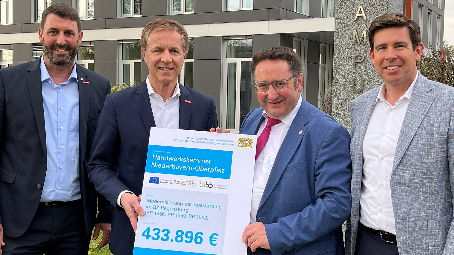 Bayerns Wirtschaftsstaatssekretär Gotthardt überreicht im Beisein von MdL Grossmann den Förderbescheid für ergänzende Ausstattungen an HWK-Vertreter Schmidt und Spiegler vor der Handwerkskammer.